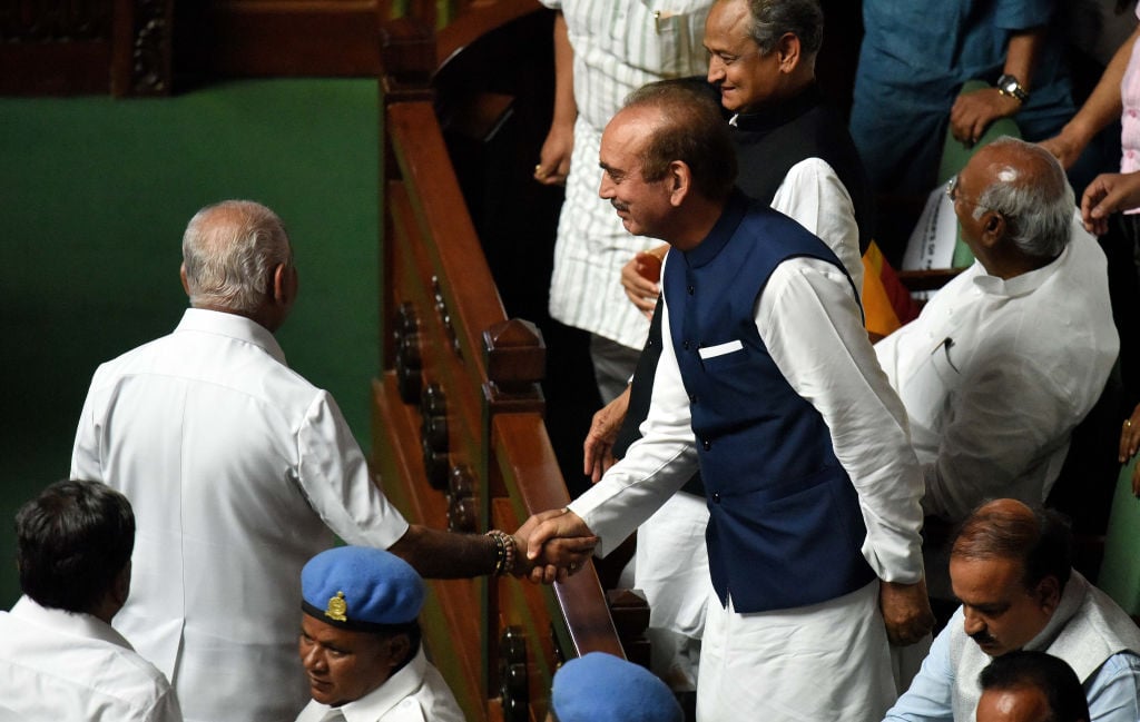 Leader of the Opposition Rajya Sabha Ghulam Nabi Azad shakes hand with BS Yeddyurappa after he resigned as the 23rd Chief Minister of Karnataka (Arijit Sen/Hindustan Times via Getty Images)